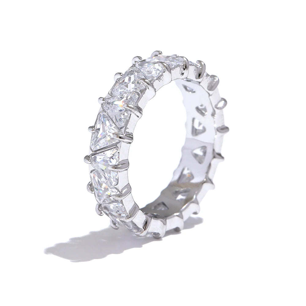 Silver ring with clear gemstones on a white background