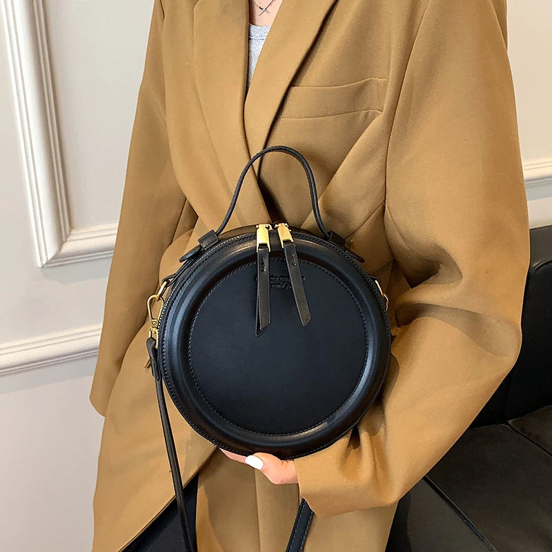 Leather Round Crossbody Bag with Gold Zipper and Adjustable Strap