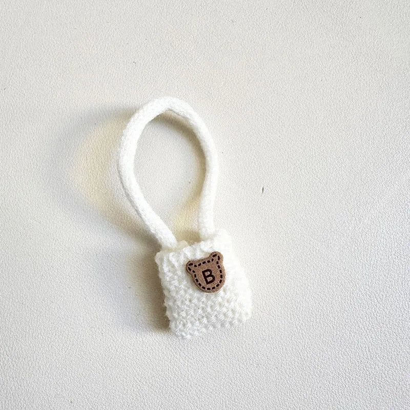 White textured ring with a brown 'B' on a light gray background