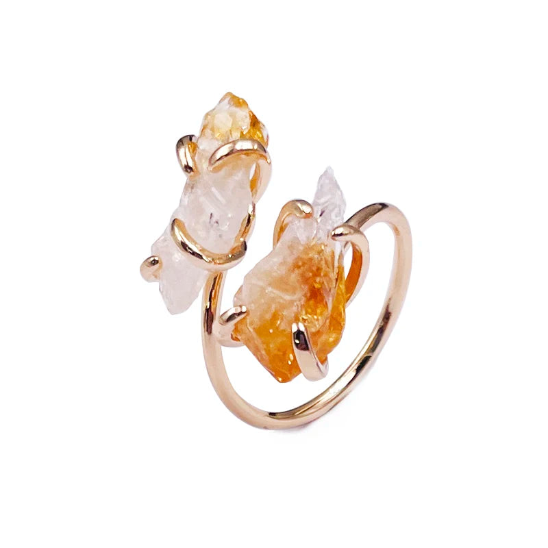 Gold ring with natural stone elements on a white background