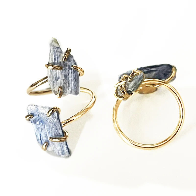 Two gold rings with natural stone accents on a white background