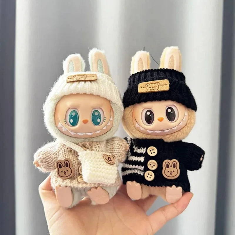 Two labubu plush toys resembling characters in winter outfits held against a neutral background