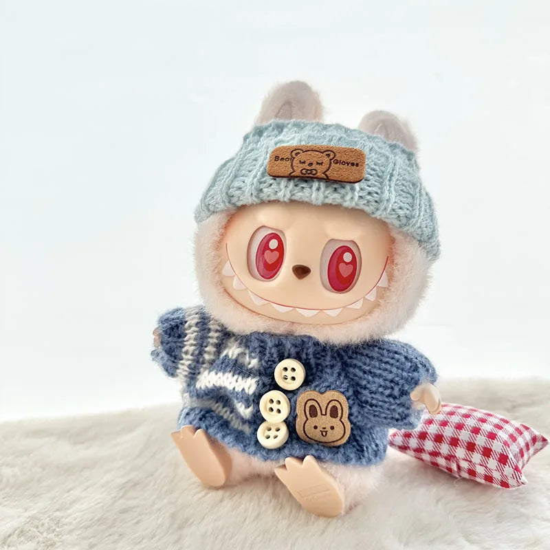Labubu Toy figure with a blue knitted hat and sweater on a white background