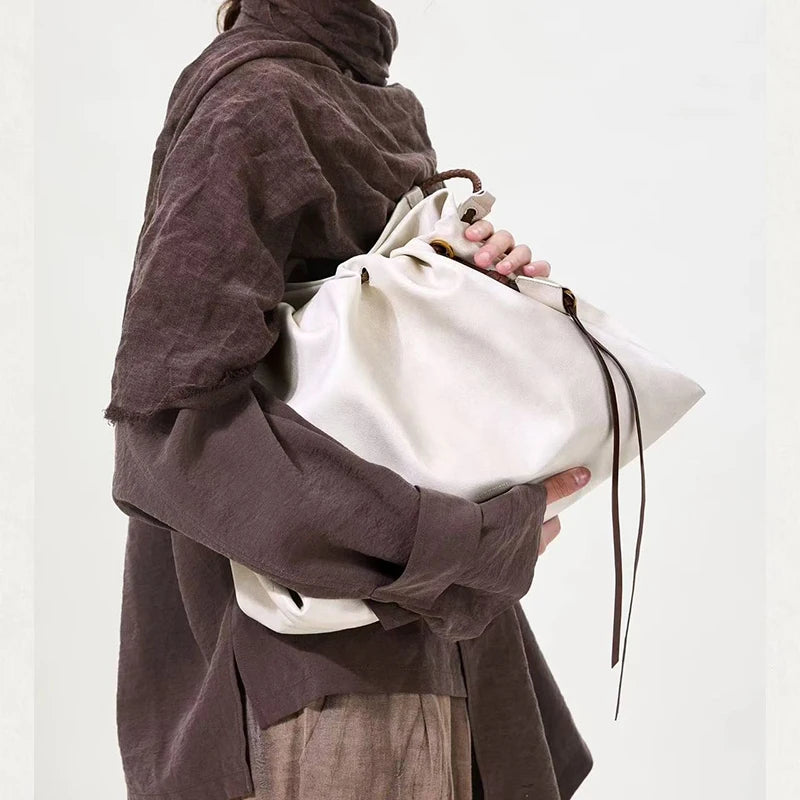 White Leather Bucket Bag with Braided Handle and Adjustable Strap