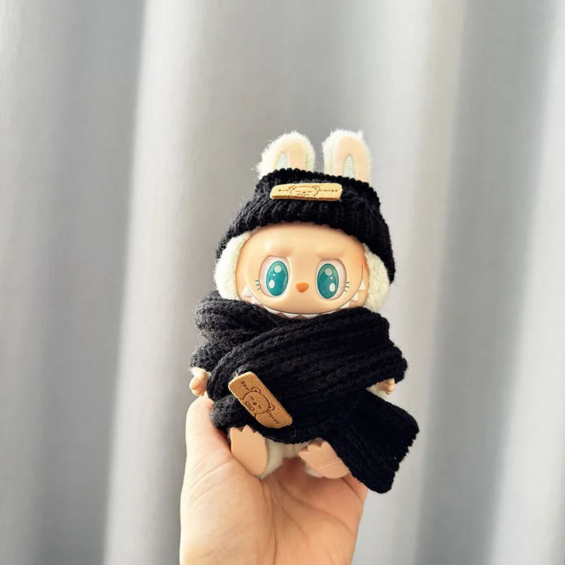 labubu Toy figure wearing a black hat and scarf against a neutral background