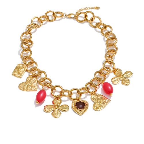 Gold bracelet with various charms on a white background