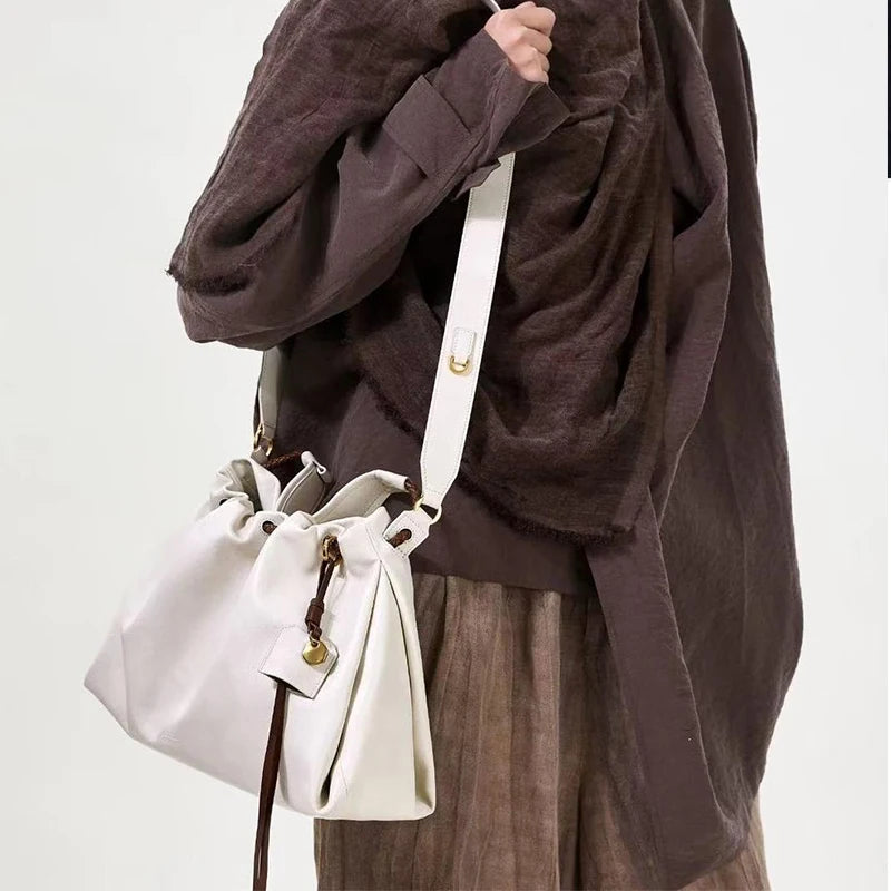 White Leather Bucket Bag with Braided Handle and Adjustable Strap