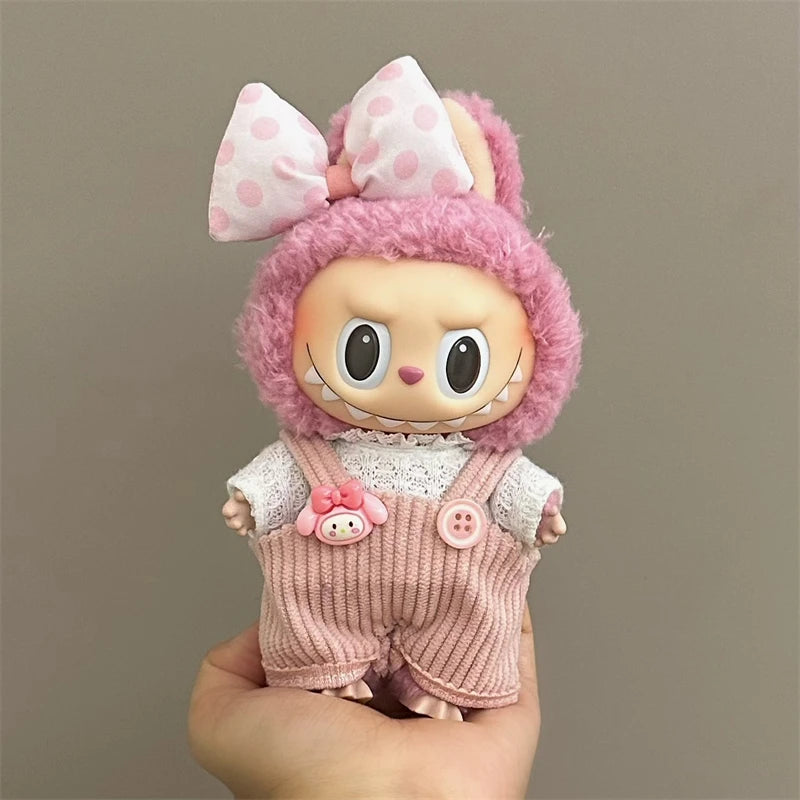 Labubu Toy figure with pink hair and outfit held against a plain background
