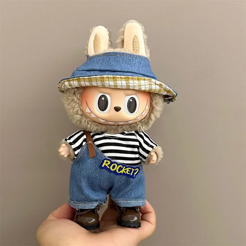 labubu Toy figure with bunny ears and a denim outfit, held against a plain background