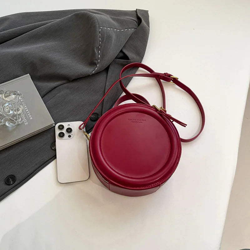 Leather Round Crossbody Bag with Gold Zipper and Adjustable Strap