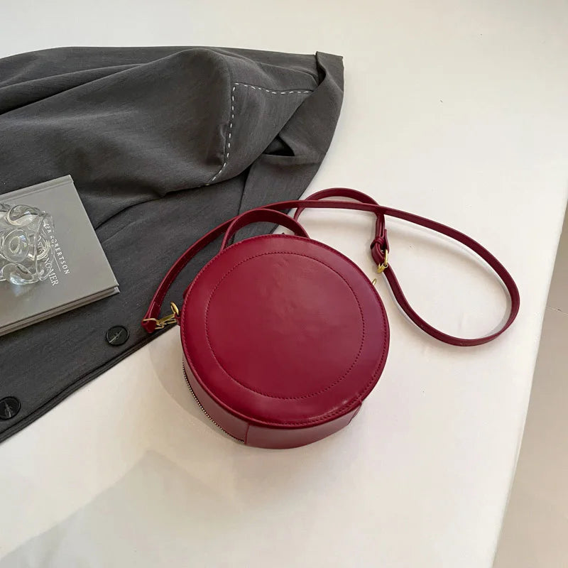 Leather Round Crossbody Bag with Gold Zipper and Adjustable Strap
