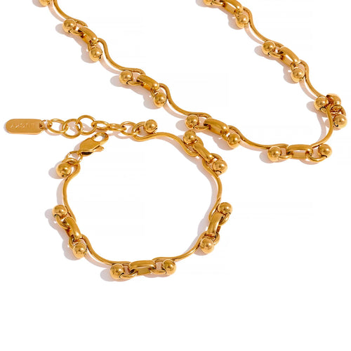 Gold chain necklace and bracelet on a white background