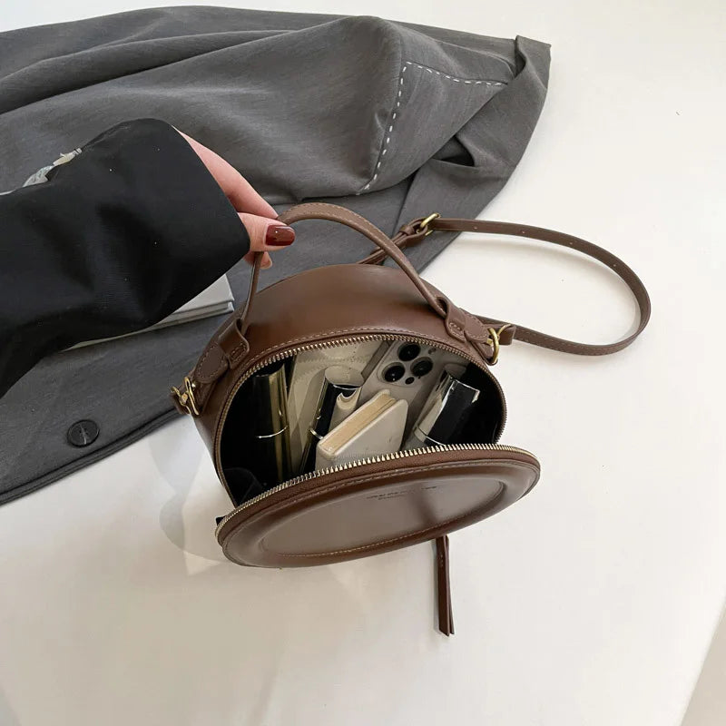 Leather Round Crossbody Bag with Gold Zipper and Adjustable Strap