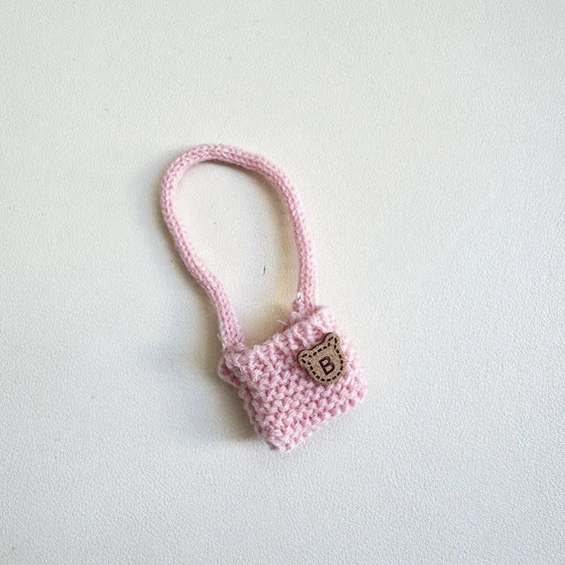 Pink crocheted bag with a letter 'B' on a white background