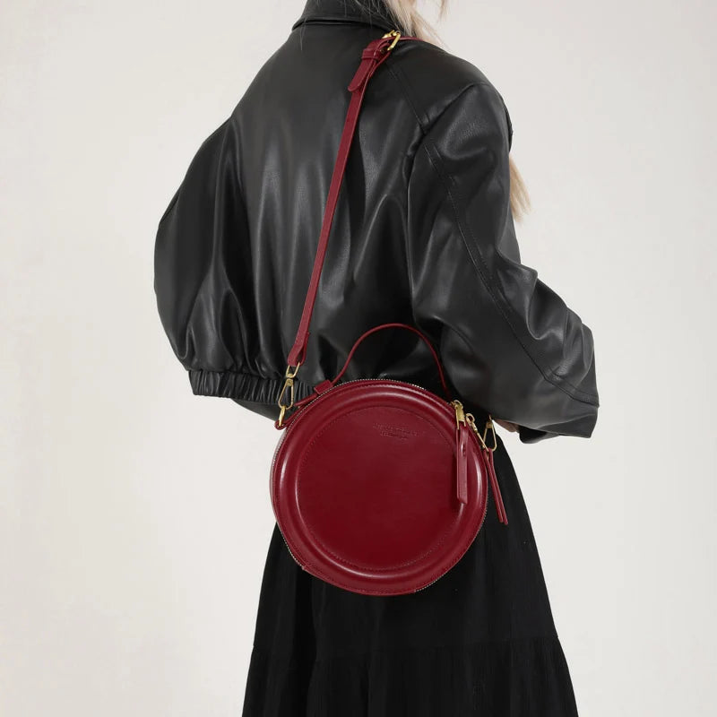 Leather Round Crossbody Bag with Gold Zipper and Adjustable Strap
