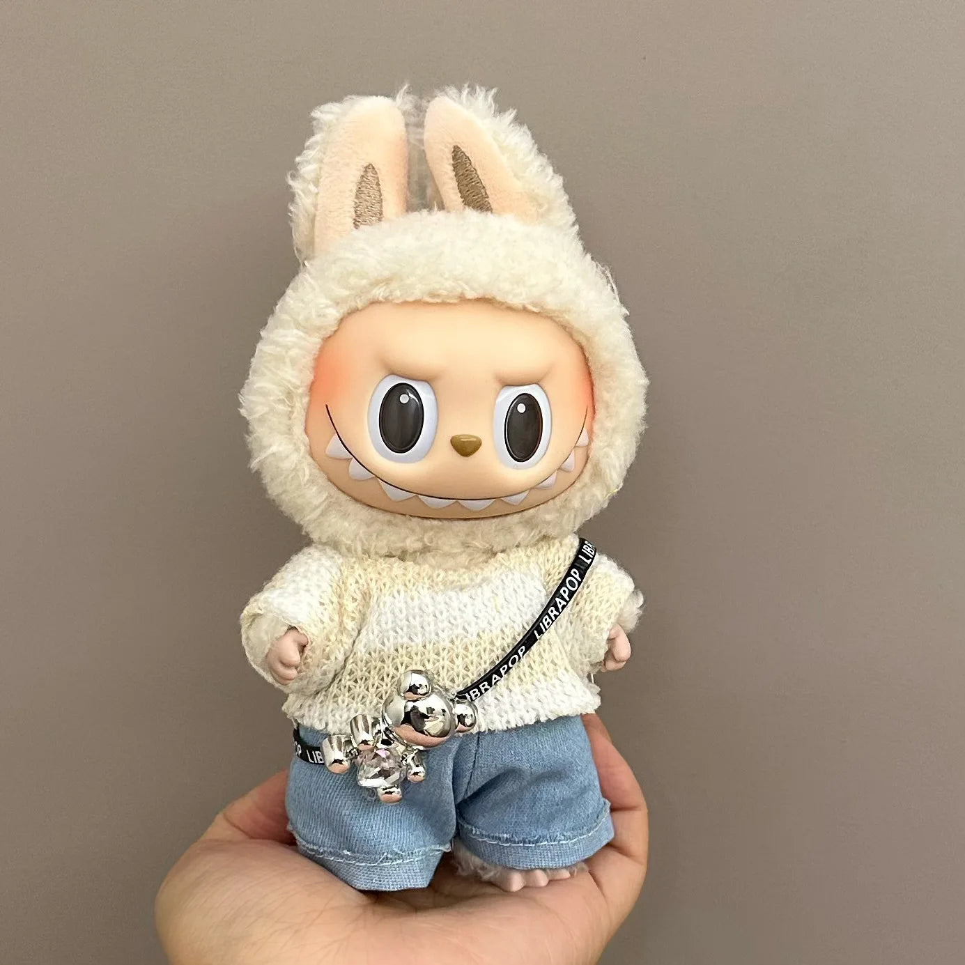 Toy figure of a character in a bunny costume with denim shorts and a white sweater.