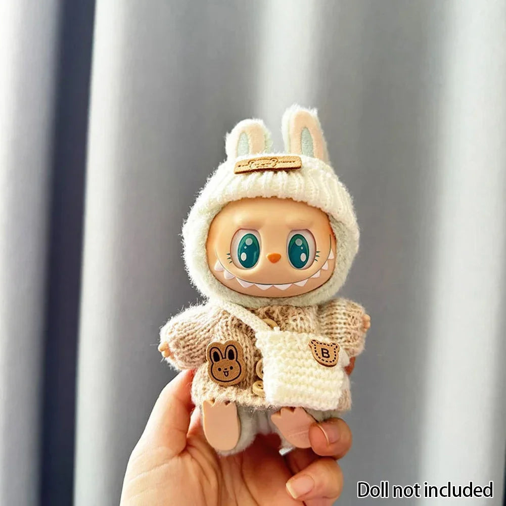 Labubu Toy figure in a bunny costume held by a hand against a gray background