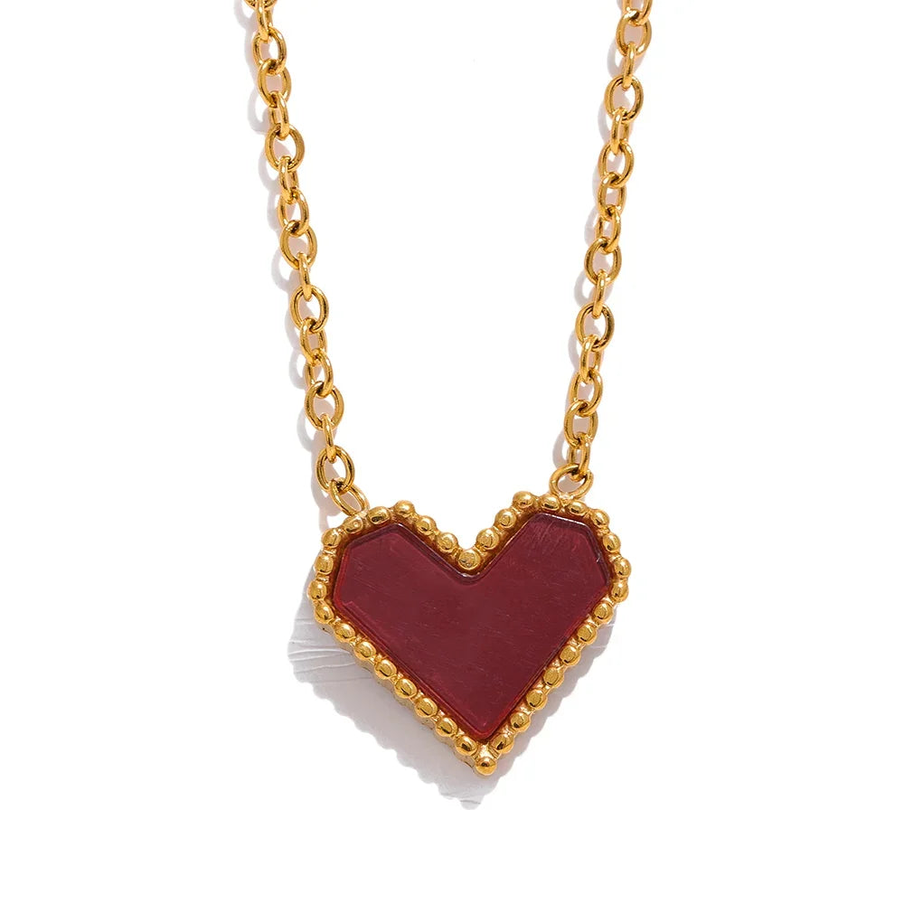 Heart-shaped pendant necklace with gold chain on a white background